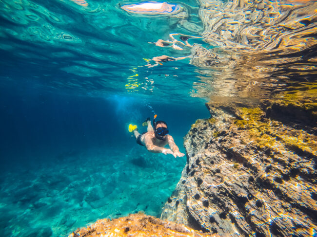 Men snorkeling by the reef